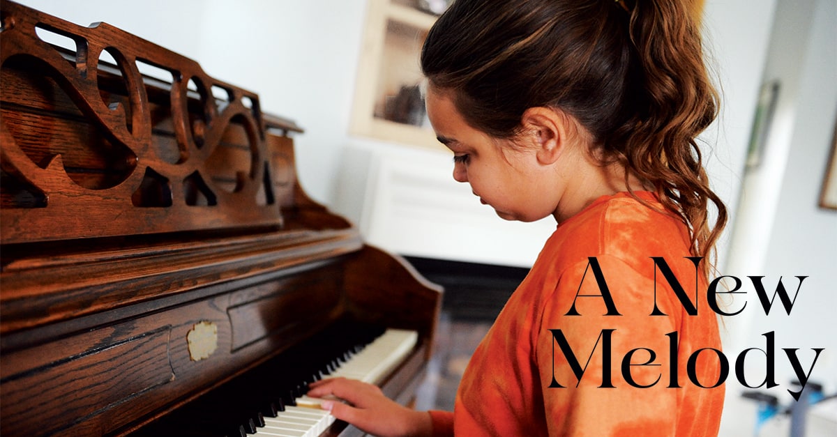Title Image with a Girl in Orange Shirt Playing a Piano